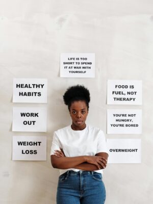 A woman stands in front of health messages promoting positive lifestyle changes.