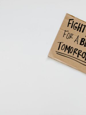 Handwritten motivational message on cardboard for a better future.
